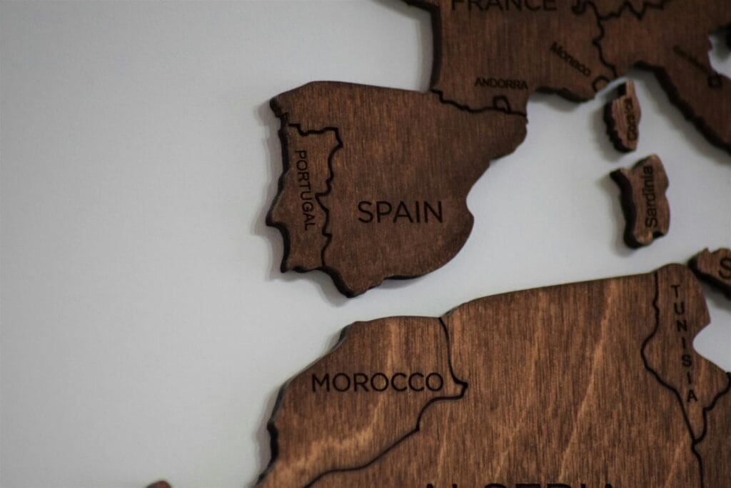 Artistic wooden map showcasing Spain, Portugal, and surrounding regions.